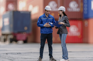 Industrial engineer standing at shipping container yard inspecting cargo delivering loading as...