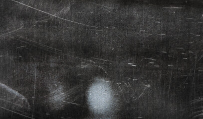 A textured, worn black surface with scratches and scuffs, offering a vintage and artistic appeal...