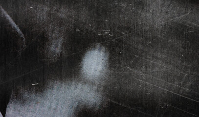 A textured, worn black surface with scratches and scuffs, offering a vintage and artistic appeal...