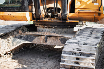 Heavy machinery tracks on a construction site after a day of work in the afternoon sun