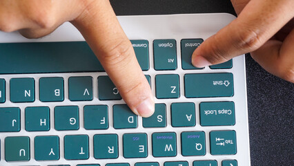 Finger pressing control and S or ctrl + S shortcut keys for save on a green wireless computer...