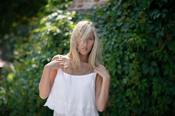 Outdoor portrait of beautiful young woman with green eyes at summertime.