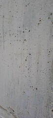 Plain concrete wall with small holes