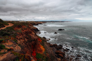 Lighthouse on the shore of the Atlantic Ocean in dramatic light