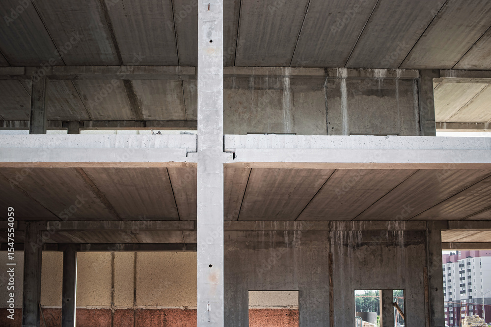 Poster construction site with exposed concrete framework showing progress on a new building in a city envir