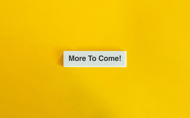 More To Come Letter Tile on Yellow Background – Minimalist Future-Oriented Concept