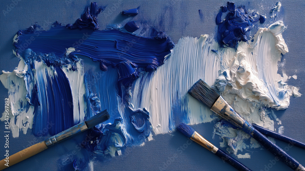 Aufkleber Dynamic blue and white paint strokes sweep across canvas, creating textured and vibrant abstract artwork. Three paintbrushes lie on surface, adding to creative scene