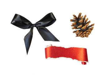 christmas decorations with black ribbon bow, pine cone and glitter paper roll banner isolated on...