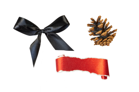 christmas decorations with black ribbon bow, pine cone and glitter paper roll banner isolated on white or transparent png
