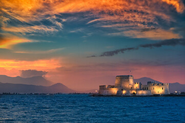 Dramatic sky sunset over the castle Bourtzi in Nafplio, Peloponnese, Greece