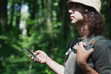 Man Using Smartphone in Forested Area