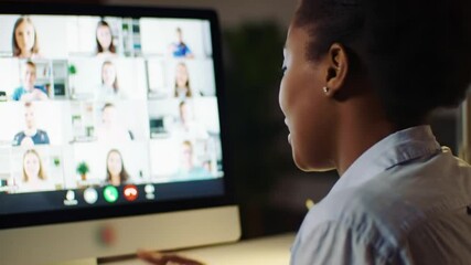 Black woman, video call and speaking for online education as english teacher on computer, night and office. Female person, communication and virtual class for distance learning and language lesson - Powered by Adobe
