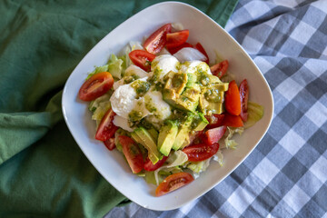 homemade summer salad with lettuce, chicken, cheese, mediterranean salad style