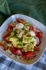 homemade summer salad with lettuce, chicken, cheese, mediterranean salad style