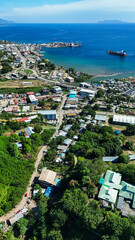 Vertical aerial view of Honiara city and the harbour in the background.