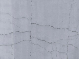 Light grey wall with intricate network of fine cracks, creating a distressed texture.