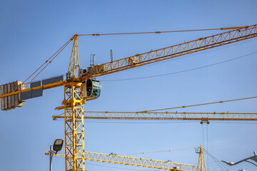 Power and precision of construction. Cranes in modern infrastructure. Building construction....
