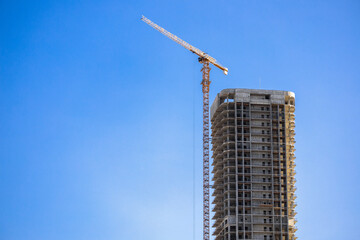 Construction crane on Housing. Construction site with buildings under construction. Tower cranes in...