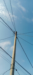 high voltage power lines against blue sky