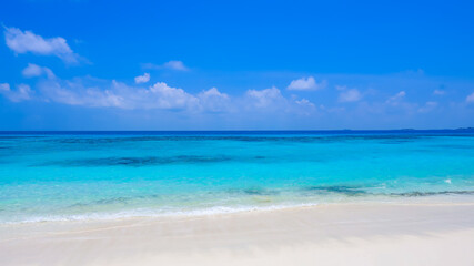 The summer vacation background with the pattern of Nature on the beach with wave of sand as sea ocean blue water in summer