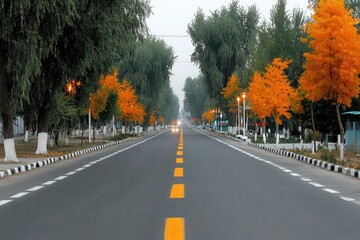 Wide city road with yellow traffic lines in the middle