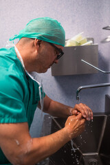 Surgeon washing hands before surgery