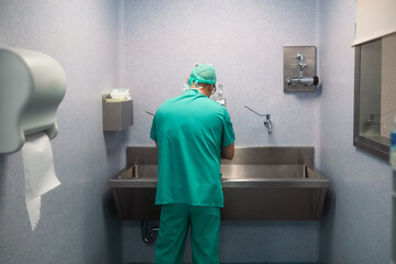 Surgeon washing hands before surgery