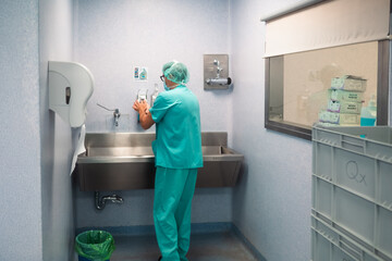 Surgeon washing hands before surgery