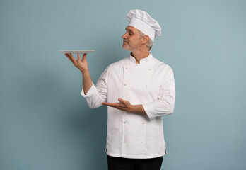 Portrait of chef, empty plate and smile, presenting menu special promo deal or restaurant product placement