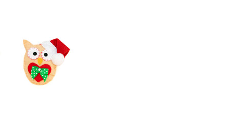 The toy owl is isolated on the white background with copy space. The atmosphere of Christmas and New Year. Christmas banner, mock-up