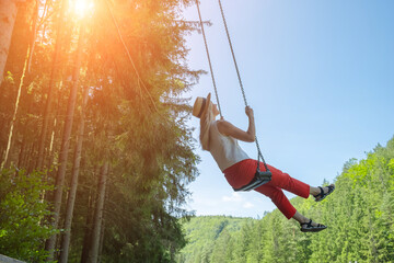 Woman Enjoying on Swing. Embraces lightness and freedom, surrounded by fresh air and greenery....