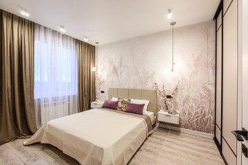 stylish bedroom with a beige bed, botanical wallpaper, and soft lighting. Curtains frame the window