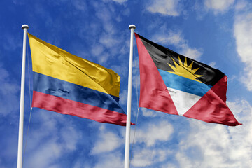 The Distinctive Flags of Colombia and Antigua and Barbuda Fly High, Waving Gracefully Against a...