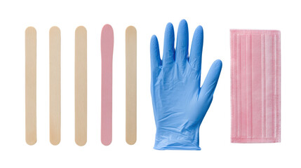 Obraz premium Medical tools including wooden sticks, a blue glove, and a pink mask arranged on a white background.