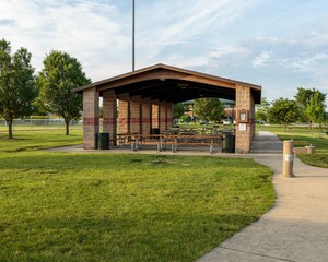 a covered picnic area or pavillion next to a baseball complex