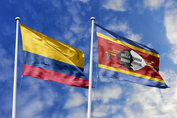 Waving Flags of Colombia and Dominica Against a Blue Sky, Symbolizing International Relations and Friendship