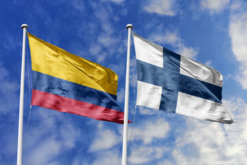 Colombia and Finland flags proudly waving side by side against a brilliant blue sky, symbolizing strong international ties, cultural exchange, and global cooperation.