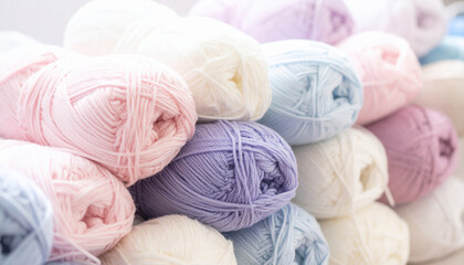 Balls of wool threads for knitting in pastel tones. Handmade, hobby and leisure concept.