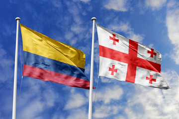 Colombia and Georgia flags majestically unfurling against a vivid blue sky, symbolizing...