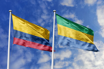 Colombia and Gabon flags gracefully waving against a beautiful blue sky, symbolizing international...