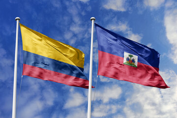 Colombia and Haiti flags majestically unfurling against a bright blue sky, symbolizing...