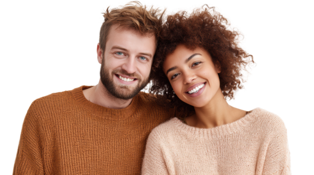 Smiling couple with curly hair in cozy sweaters, showcasing happiness and warmth against a white background.