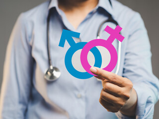 Medical professional showing sex icons for gender awareness, identity, and health care.