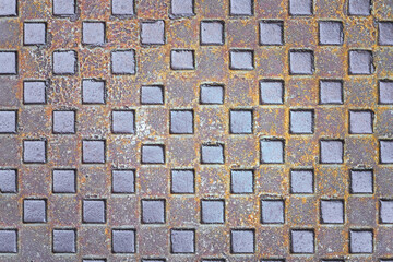 Rusted metal square plate with a repeating raised diamond pattern. Ideal for backgrounds,...