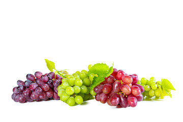 Bunches of green and red juicy grapes with leaves isolated on white.