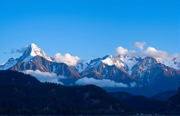 Snow - capped Mountains Towering Under Blue Sky