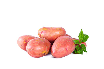 Heap of red potatoes with leaves isolated on white background.
