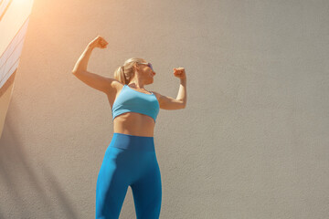 Middle-aged Woman Stretching Before Jogging on a Sunny Urban Str