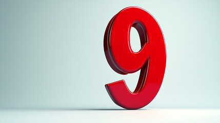 A glossy red number nine standing on a white surface against a light blue background in studio light