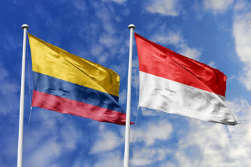 Colombia and Indonesia flags proudly flying side by side against a brilliant blue sky, symbolizing...